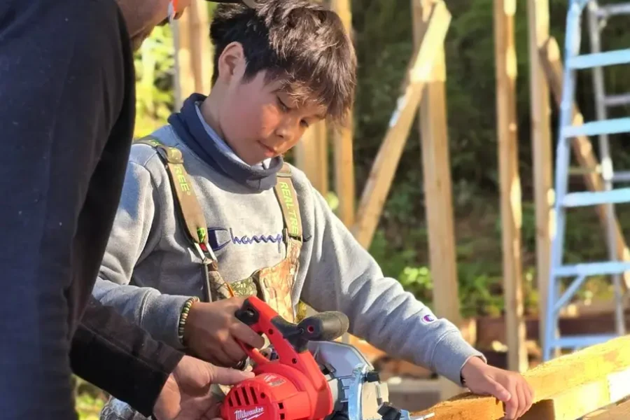 Asher learning construction skills (Tla-o-qui-aht Territory)